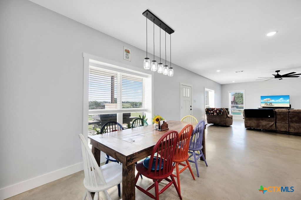 6887 Smith Dairy Road Belton, TX 76513 - Photo 23 of 48 a view of a dining room with furniture and a chandelier