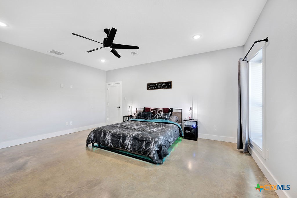 6887 Smith Dairy Road Belton, TX 76513 - Photo 25 of 48 a bedroom with a bed and a ceiling fan