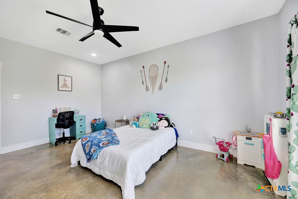 6887 Smith Dairy Road Belton, TX 76513 - Photo 26 of 48 a bedroom with a bed and cabinets