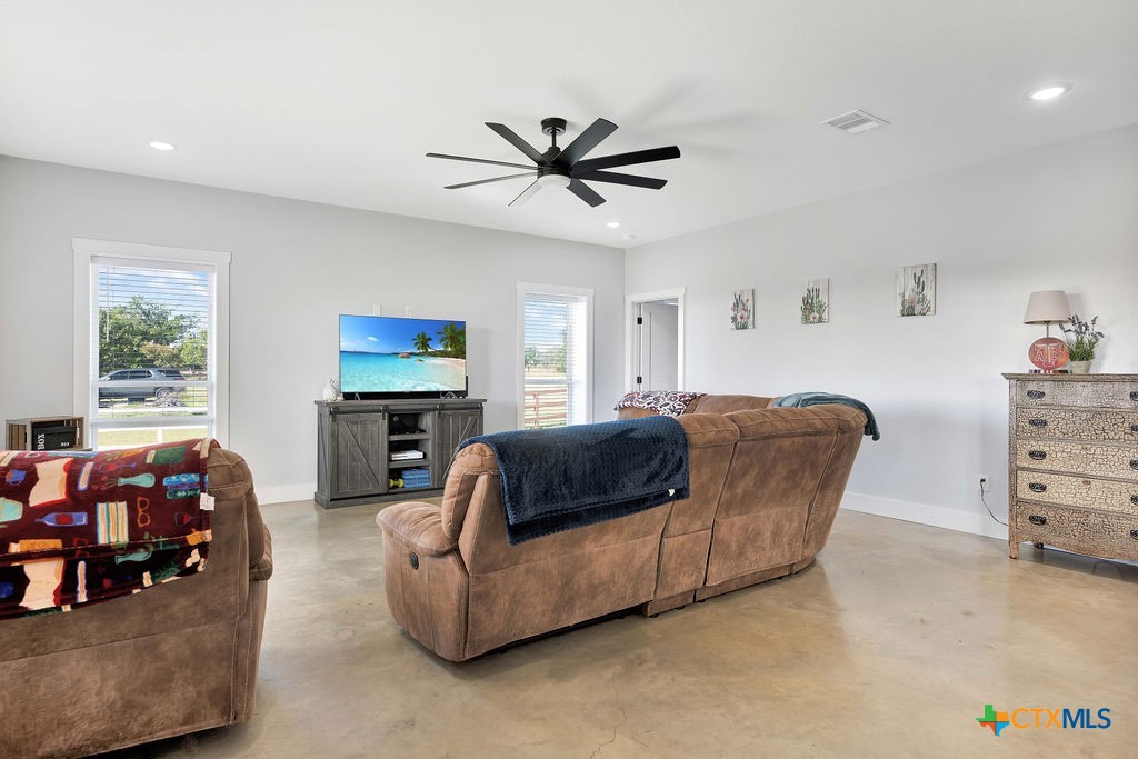6887 Smith Dairy Road Belton, TX 76513 - Photo 30 of 48 a living room with furniture a ceiling fan and a window