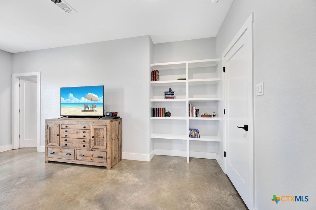 6887 Smith Dairy Road Belton, TX 76513 - Photo 3 of 48 a view of an empty room with shelves