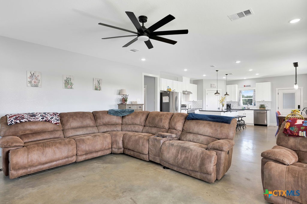 6887 Smith Dairy Road Belton, TX 76513 - Photo 31 of 48 a living room with furniture and a view of kitchen