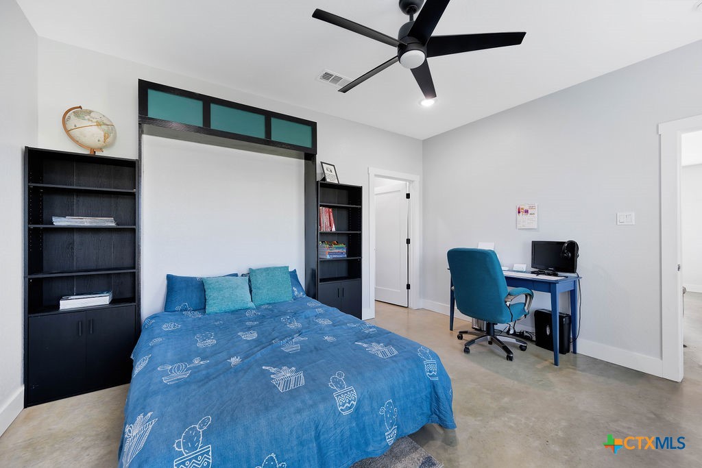 6887 Smith Dairy Road Belton, TX 76513 - Photo 32 of 48 a bedroom with a bed and a desk