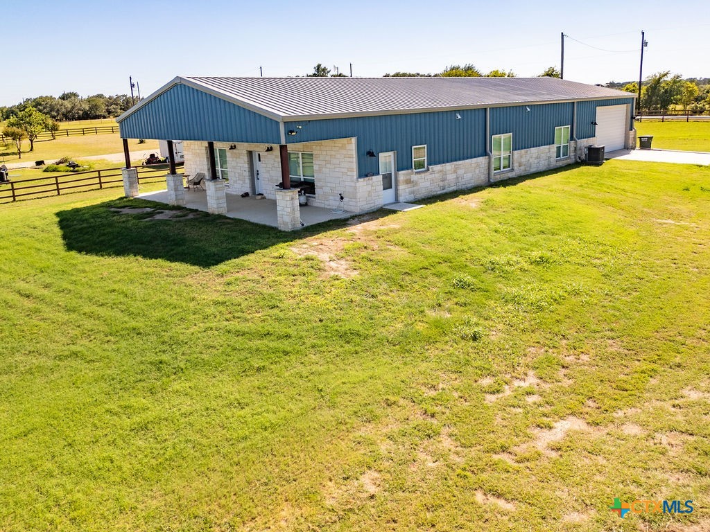6887 Smith Dairy Road Belton, TX 76513 - Photo 33 of 48 a view of a swimming pool with a lawn chairs under an umbrella