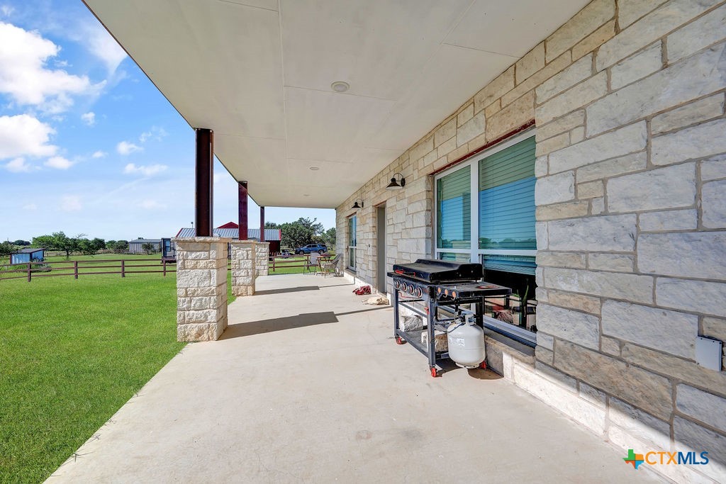 6887 Smith Dairy Road Belton, TX 76513 - Photo 34 of 48 a view of a patio with table and chairs near a garden