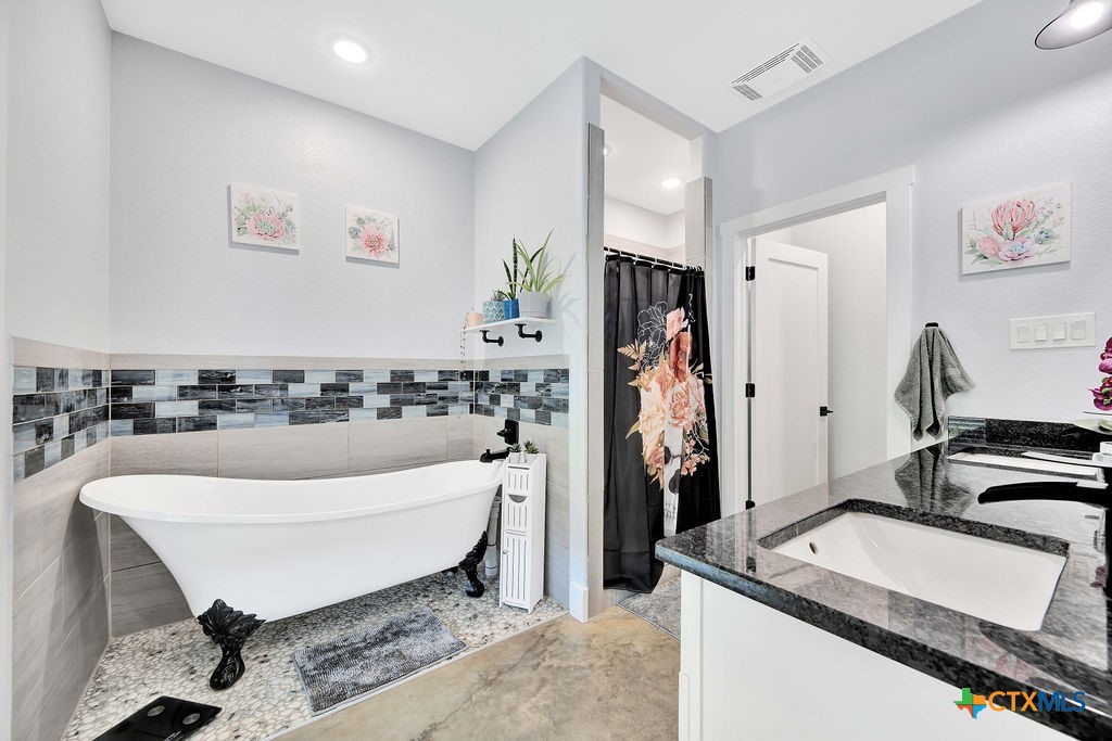 6887 Smith Dairy Road Belton, TX 76513 - Photo 4 of 48 a living room with a couch and a stove