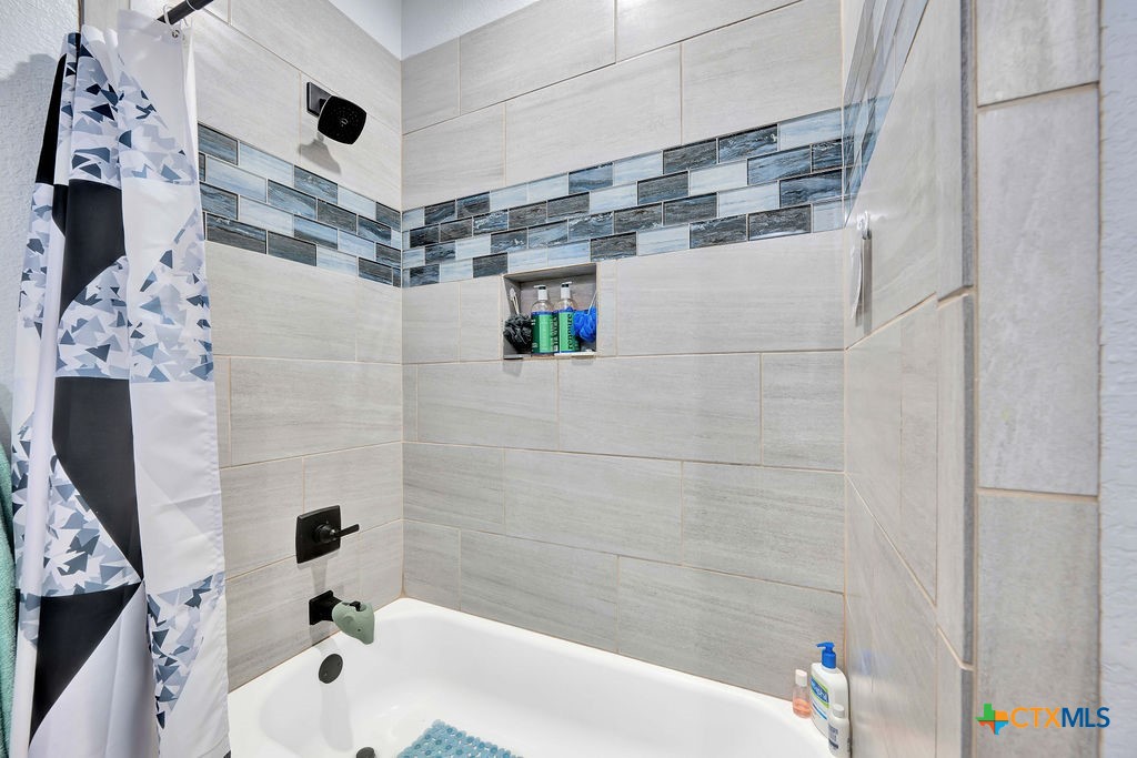 6887 Smith Dairy Road Belton, TX 76513 - Photo 9 of 48 a bathroom with a bathtub and shower