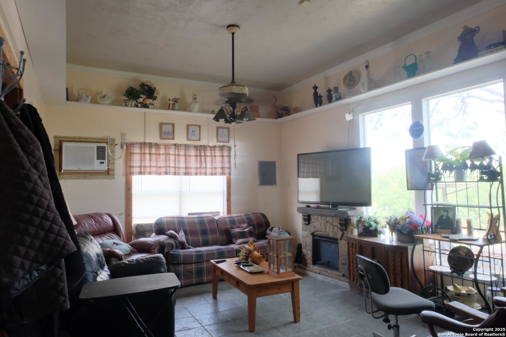 17585 Fargoer Way Marion, TX 78124 - Photo 14 of 34 a living room with furniture a flat screen tv and a large window