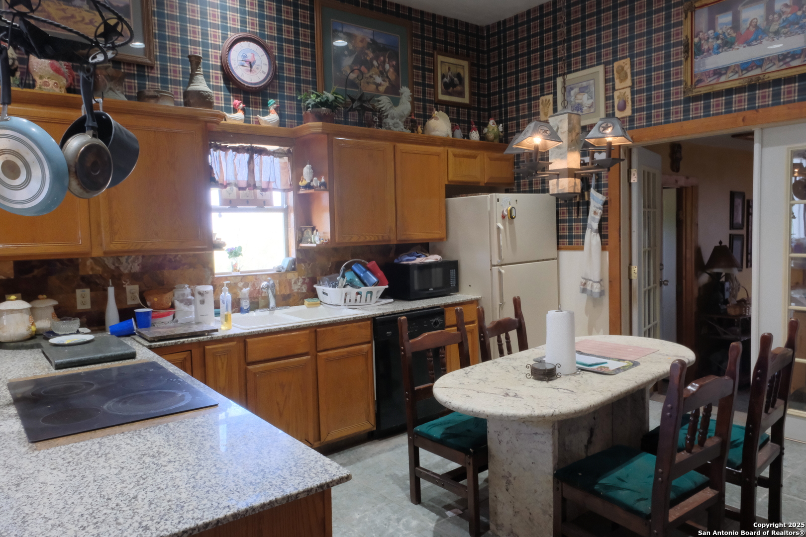 17585 Fargoer Way Marion, TX 78124 - Photo 16 of 34 a kitchen with a table chairs and a stove