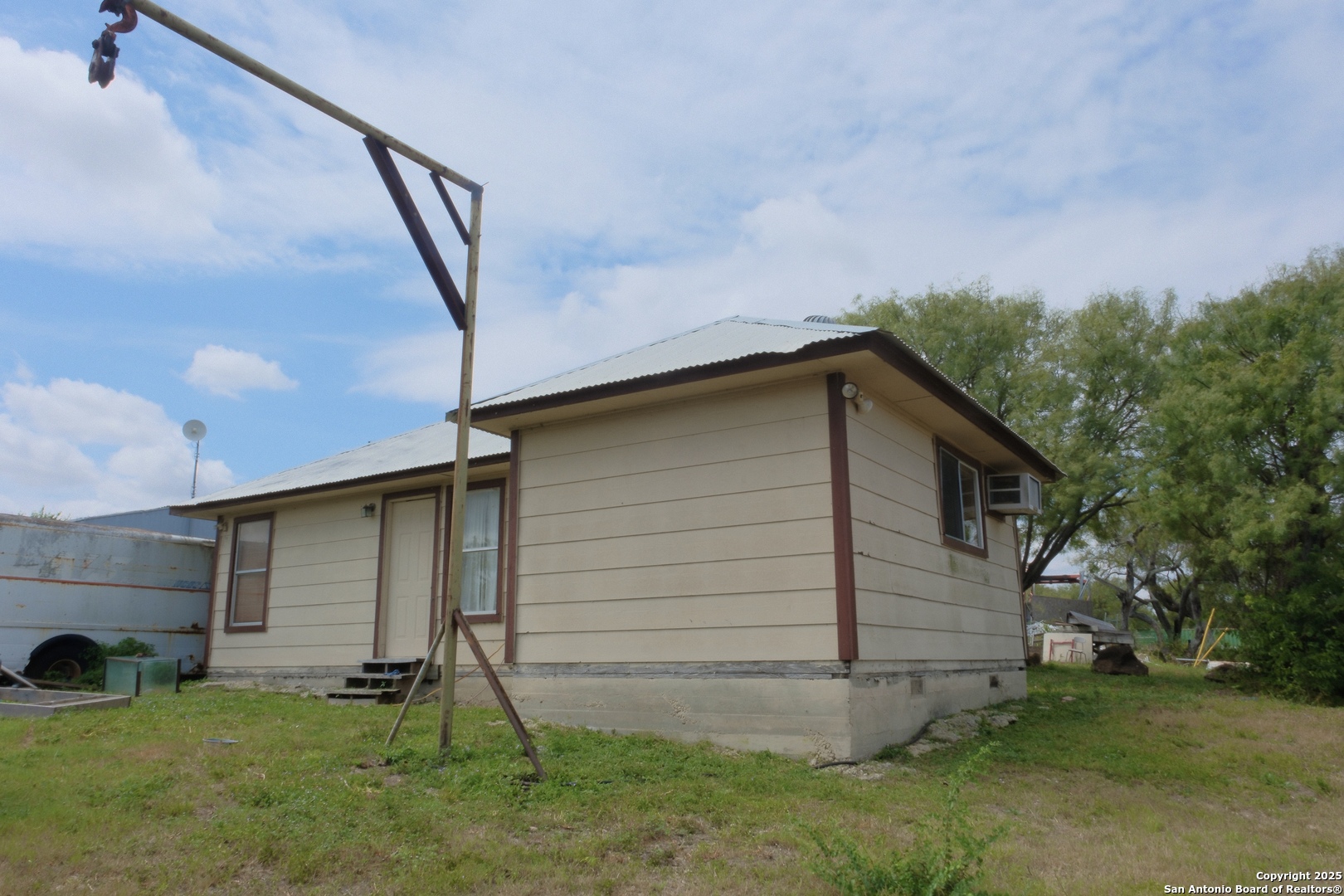 17585 Fargoer Way Marion, TX 78124 - Photo 23 of 34 a backyard of a house with potted plants and a large tree