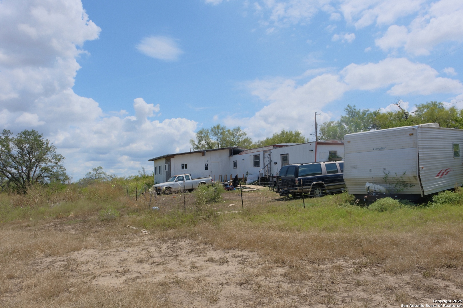 17585 Fargoer Way Marion, TX 78124 - Photo 31 of 34 a view of a lake with couches under an umbrella