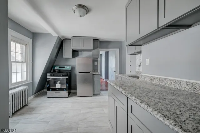 a kitchen with refrigerator and window