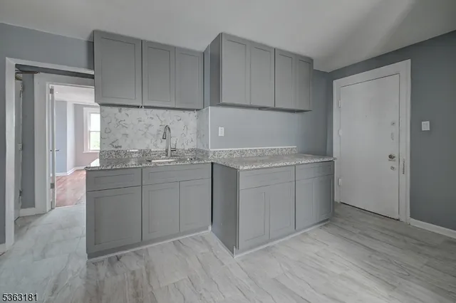 a room with a sink washer and dryer