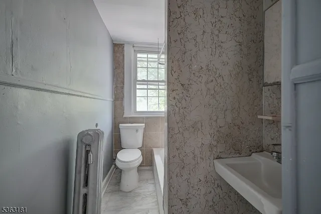 a bathroom with a sink a toilet and bathtub