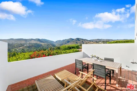 a terrace of a house with outdoor seating