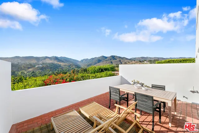 a terrace of a house with outdoor seating