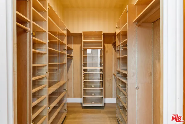 a view of walk in closet with empty racks