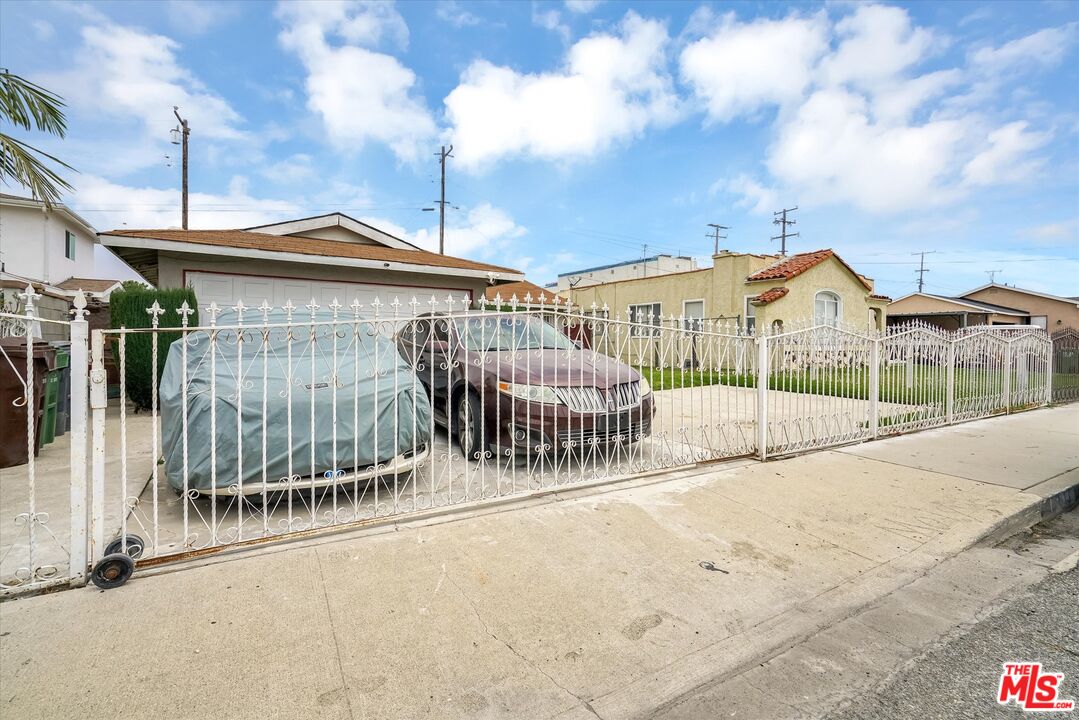 613 West Spruce Street Compton, CA 90220 - Photo 1 of 1 a view of a house with a wooden fence