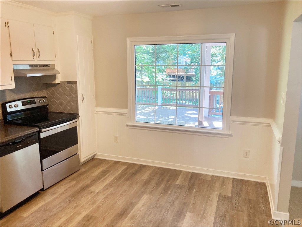 4730 Newbys Bridge Road Chesterfield, VA 23832 - Photo 8 of 24 a kitchen with a stove and wooden floor
