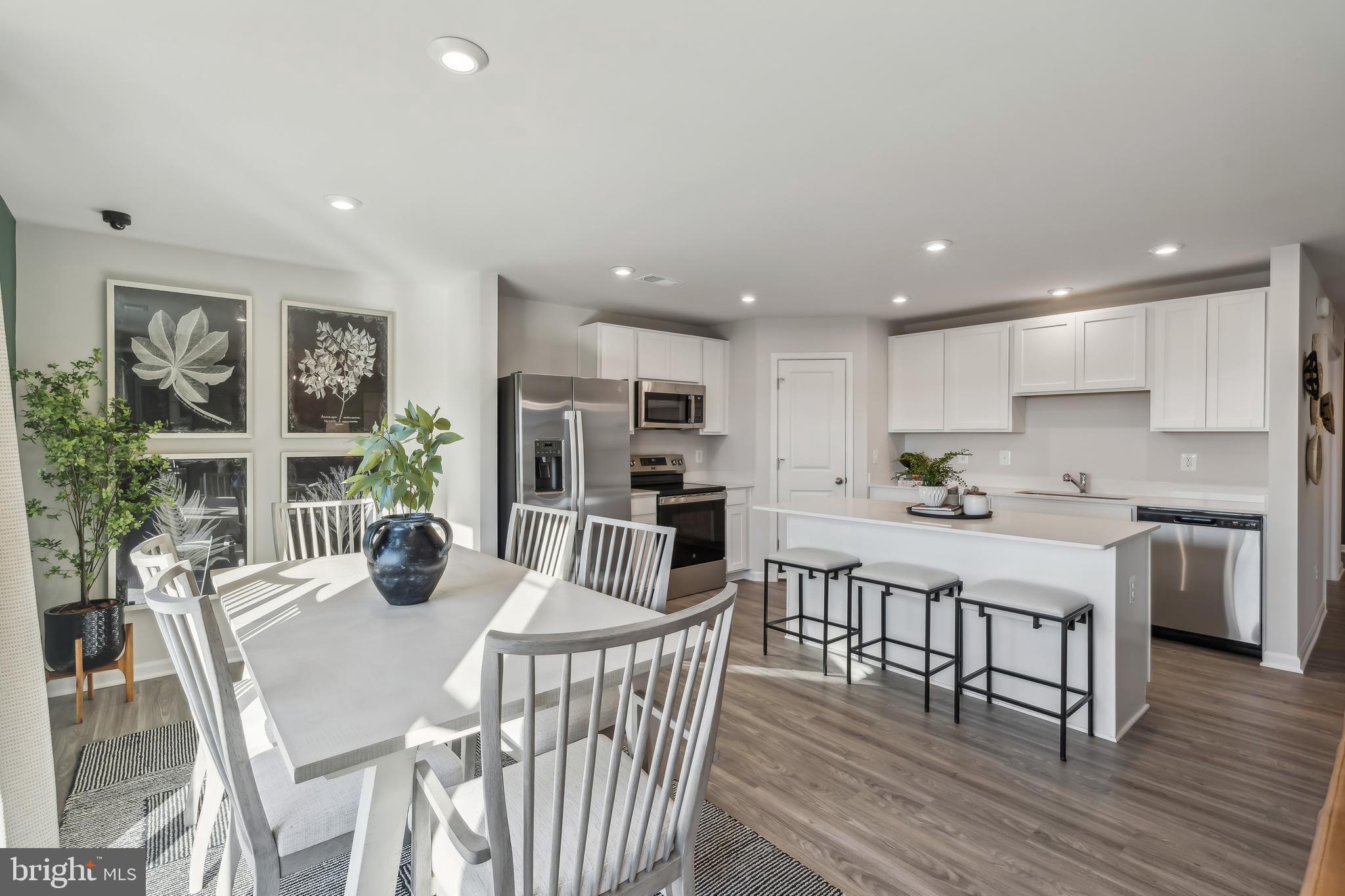 59 Vernon Street Charles Town, WV 25414 - Photo 11 of 29 a kitchen with a dining table chairs and refrigerator
