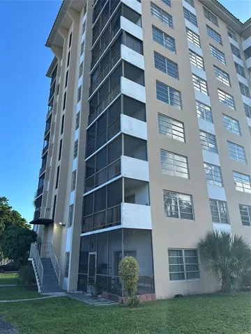 a view of a building with a yard