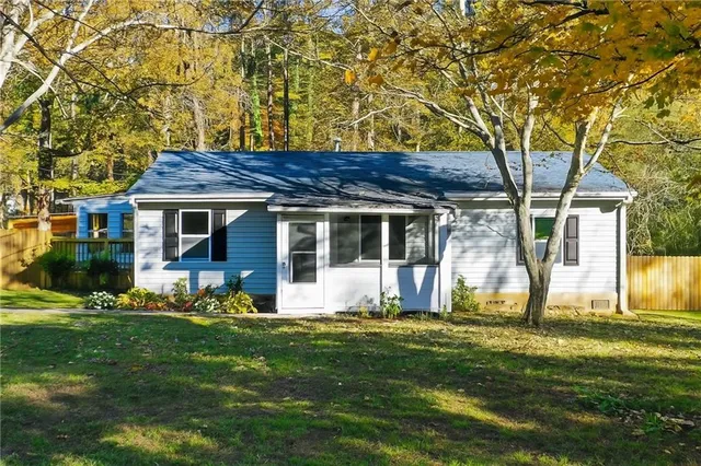 a front view of a house with a garden and porch
