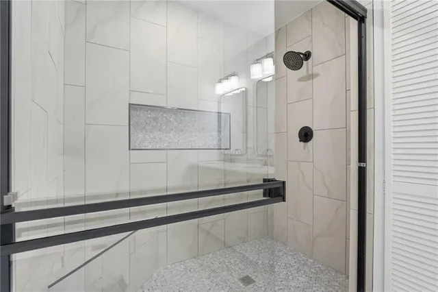 a kitchen with white cabinets and wooden floor