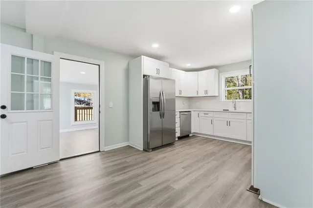 a view of a dining room with furniture and wooden floor