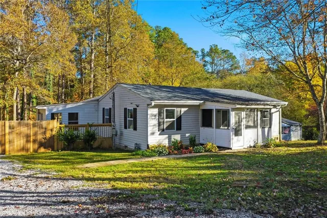 a front view of house with yard and green space