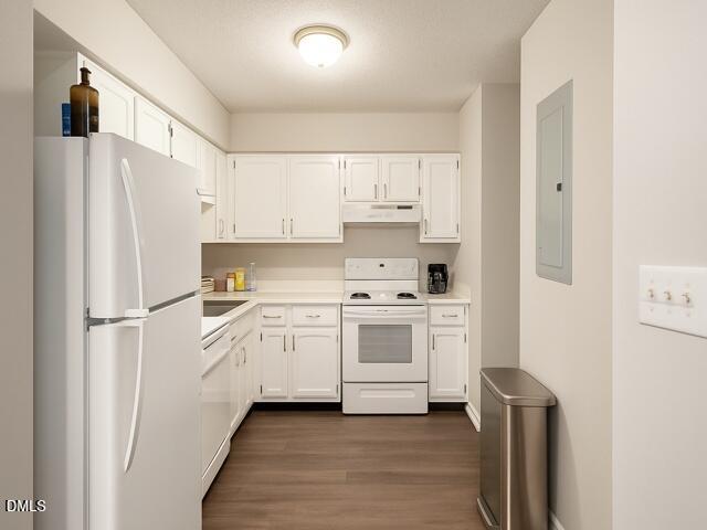 635 Pine Ridge Place Raleigh, NC 27609 - Photo 4 of 11 a kitchen with white cabinets and white appliances