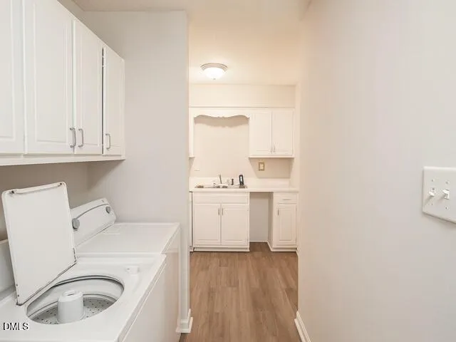a utility room with sink dryer and washer