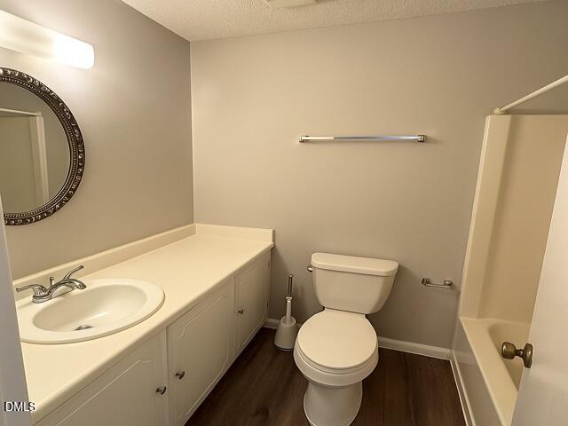 635 Pine Ridge Place Raleigh, NC 27609 - Photo 7 of 11 a bathroom with a granite countertop toilet and a sink