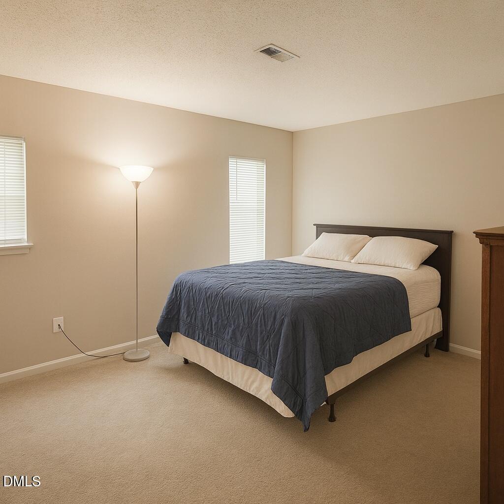 635 Pine Ridge Place Raleigh, NC 27609 - Photo 8 of 11 a bedroom with a bed and window