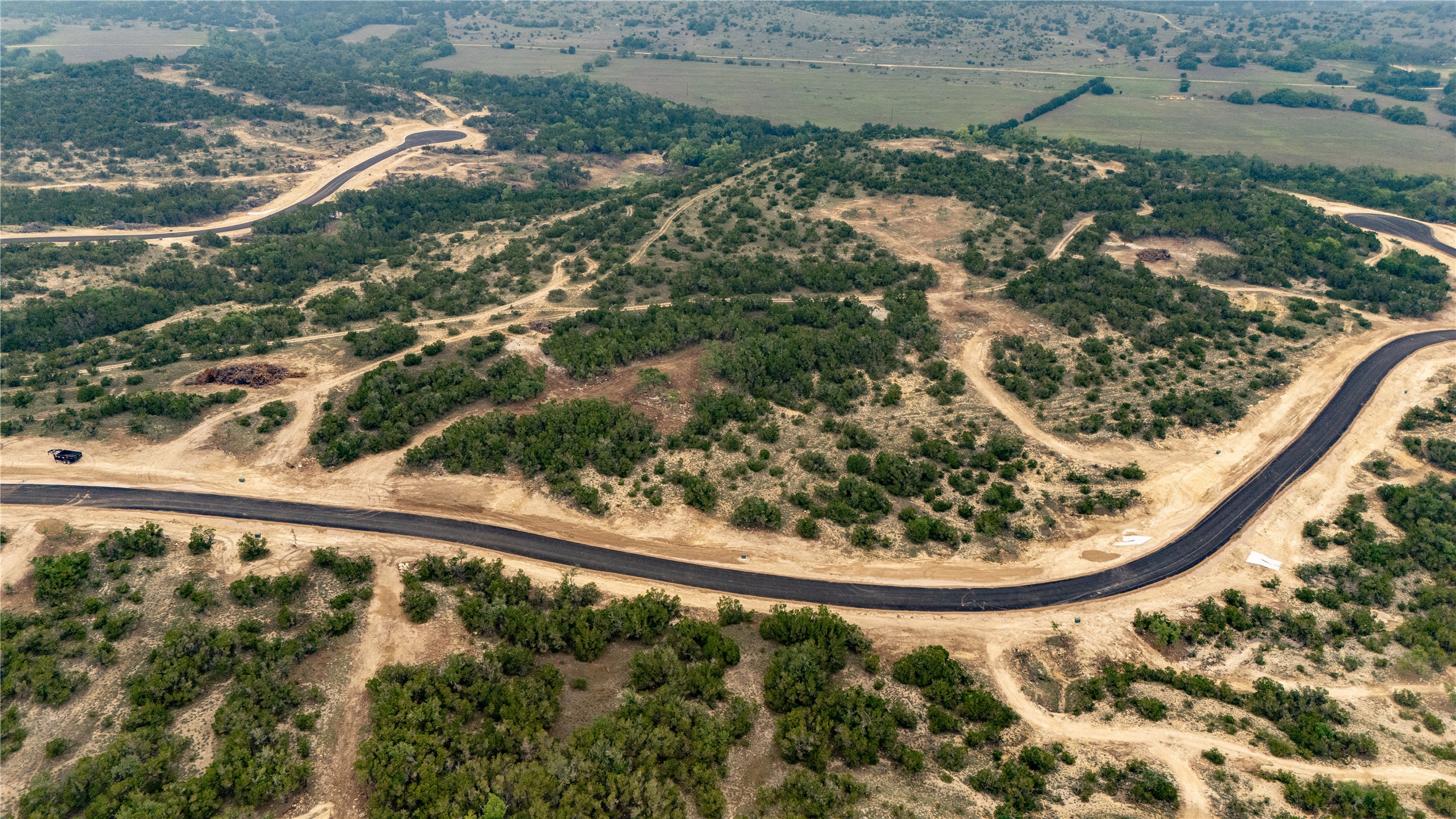 Lot 20 Ranch Road 165 Dripping Springs, TX 78620 - Photo 2 of 9 Aerial landscape featuring newly paved roads winding through natural terrain