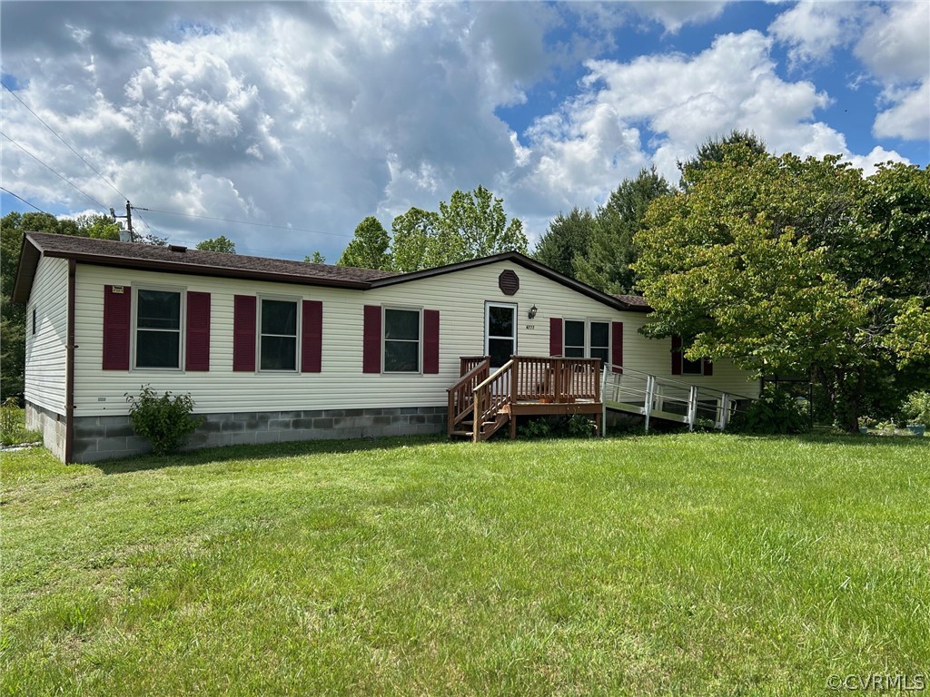 a view of a house with a yard and sitting area