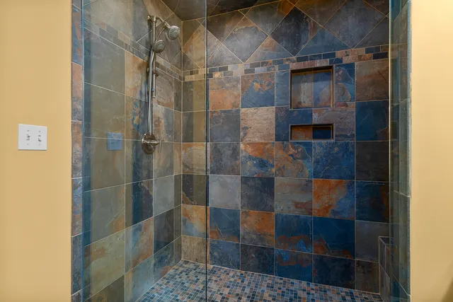 a bathroom with a glass shower door