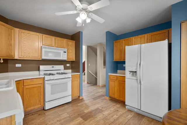a kitchen with stainless steel appliances a stove a refrigerator and a sink