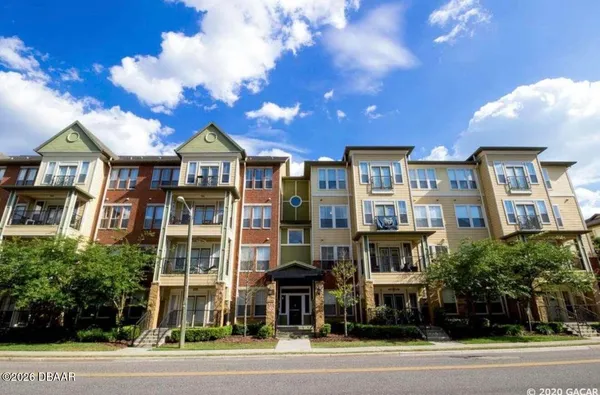 a view of a large building next to a yard