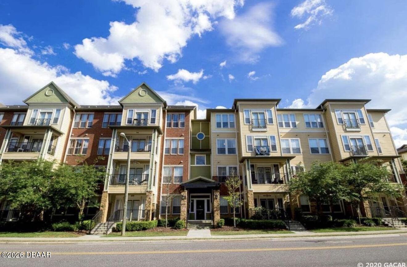 1185 Southwest 9th Road Gainesville, FL 32601 - Photo 1 of 25 a view of a large building next to a yard