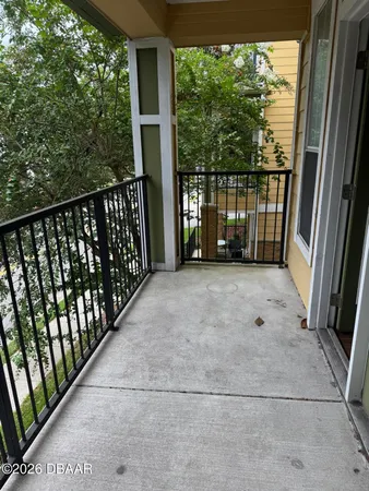 a view of a balcony with yard