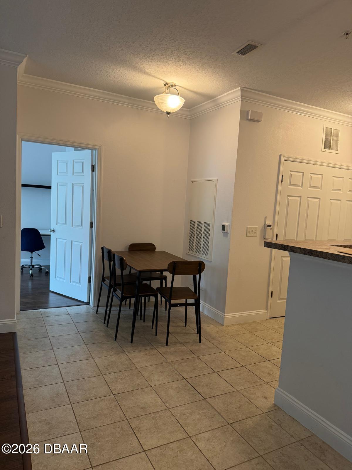 1185 Southwest 9th Road Gainesville, FL 32601 - Photo 21 of 25 a view of a dining area with furniture and a chandelier