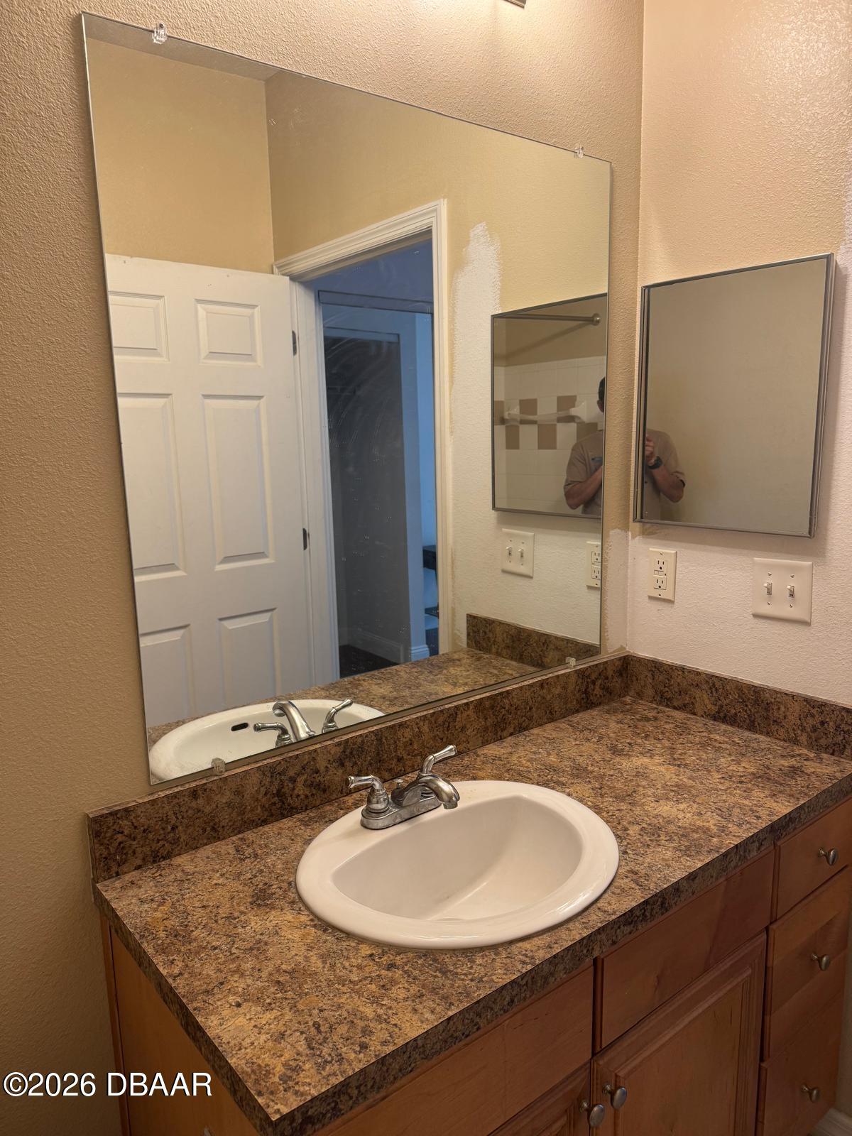 1185 Southwest 9th Road Gainesville, FL 32601 - Photo 4 of 25 a bathroom with a granite countertop sink and a mirror