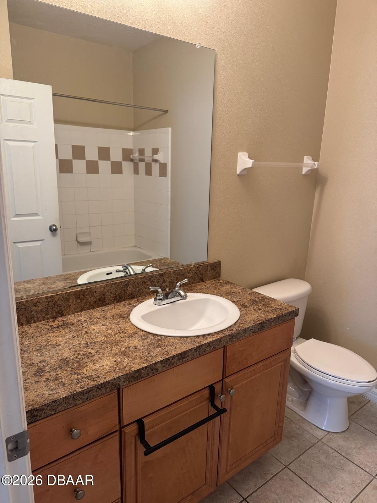 1185 Southwest 9th Road Gainesville, FL 32601 - Photo 5 of 25 a bathroom with a granite countertop sink a toilet and a mirror