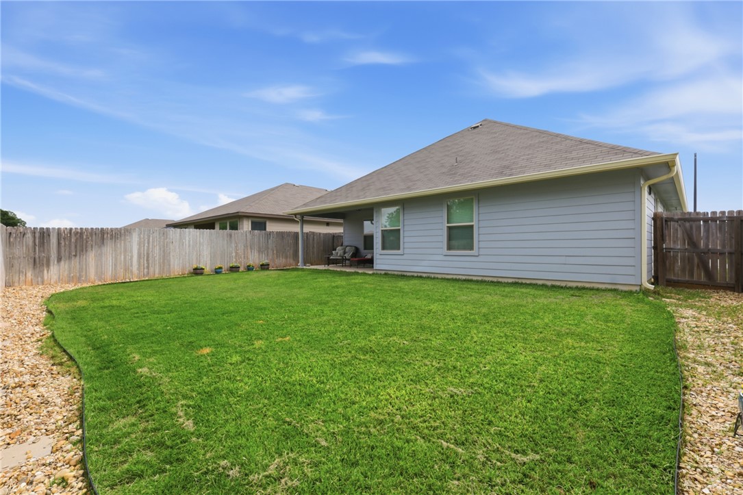 1943 Thorndyke Lane Bryan, TX 77807 - Photo 27 of 28 Upgraded landscaping along the edge of the yard with river rock