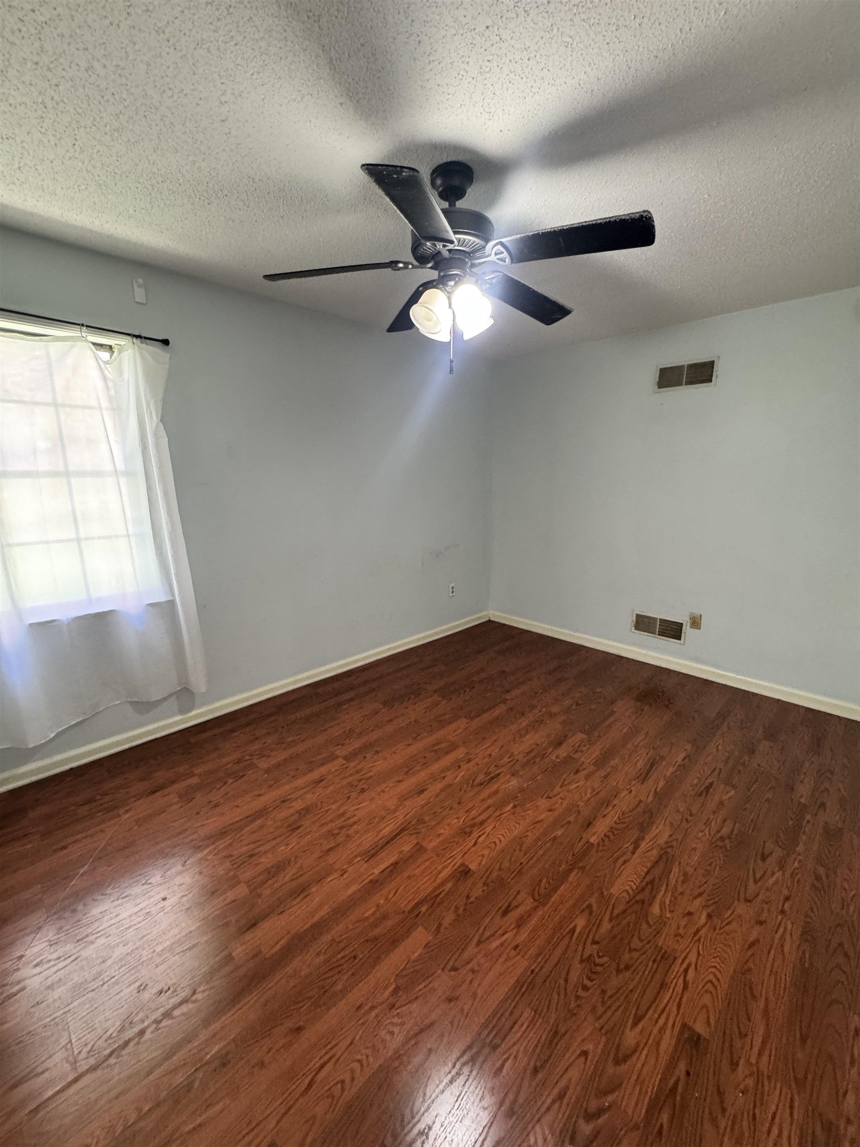 4334 Timber Rise Road Memphis, TN 38125 - Photo 13 of 18 Room featuring wood-finish flooring, a ceiling fan with integrated lighting, and light-toned wall paint