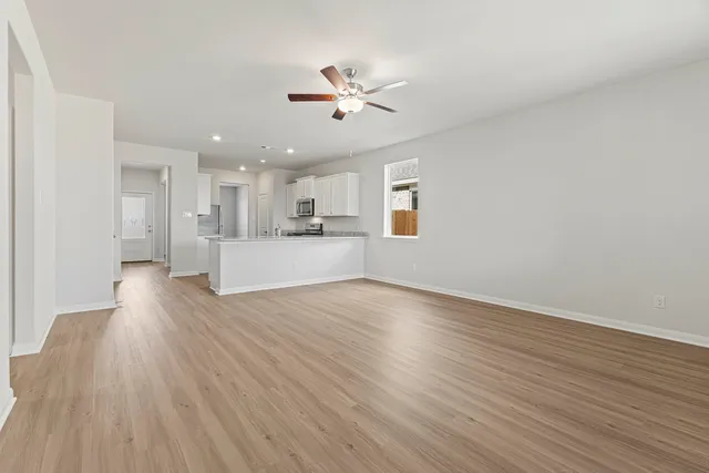 a view of kitchen with kitchen island sink stainless steel appliances and cabinets