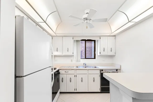 a kitchen with stainless steel appliances a sink and a refrigerator