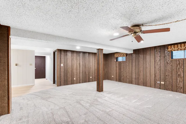 a view of a livingroom with a ceiling fan and window