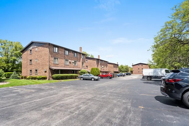 a view of a house with a cars park next to a road