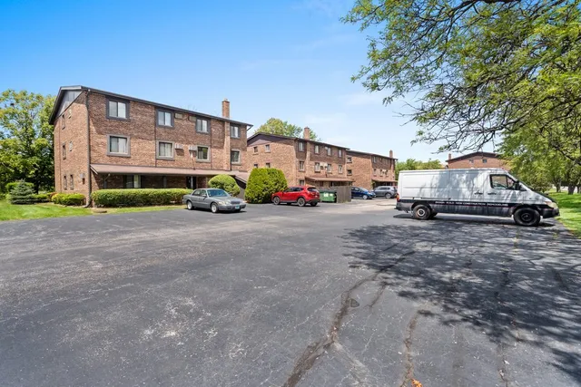 a car parked in front of a white house